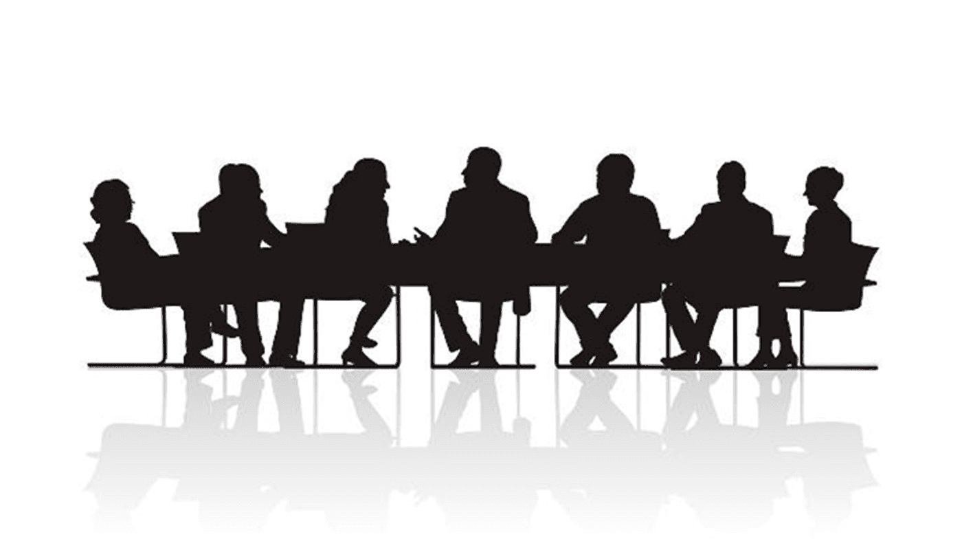 Silhouette of people sitting around a conference table, engaged in discussion.